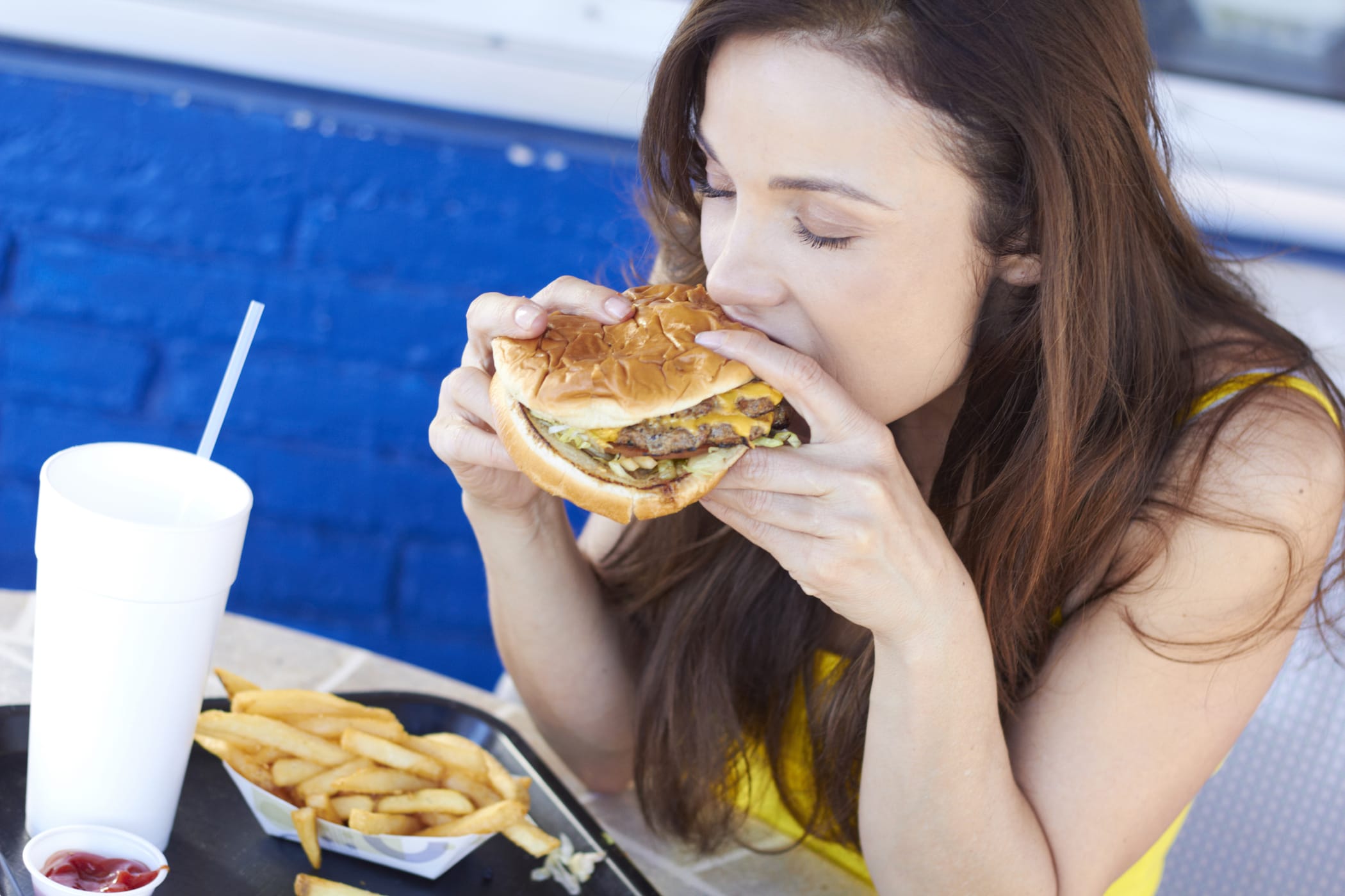 Girl eating a burger.